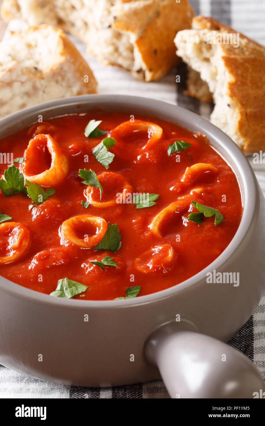 Italian cuisine spicy squid in tomato sauce close-up in a bowl