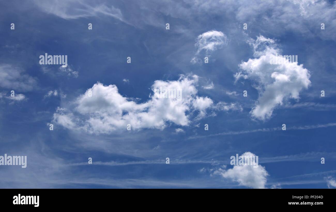 Puffy white clouds blue sky day with bright sun shining bright 4K video ...