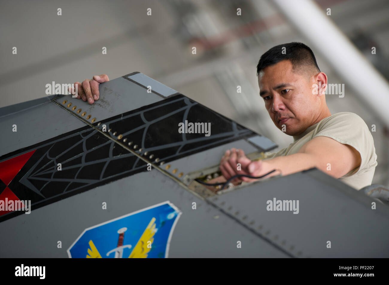 Tech. Sgt. Ritchie Videna, 455th Expeditionary Aircraft Maintenance Squadron avionics specialist, replaces a recently repaired Very High Frequency AM antenna on an F-16 Fighting Falcon assigned to the 421st Expeditionary Fighter Squadron at Bagram Air Field, Afghanistan, Feb. 24, 2016. The 455th EAMXS ensures aircraft are prepared for flight and return them to a mission-ready state once they land. (U.S. Air Force photo/Tech. Sgt. Robert Cloys) Stock Photo
