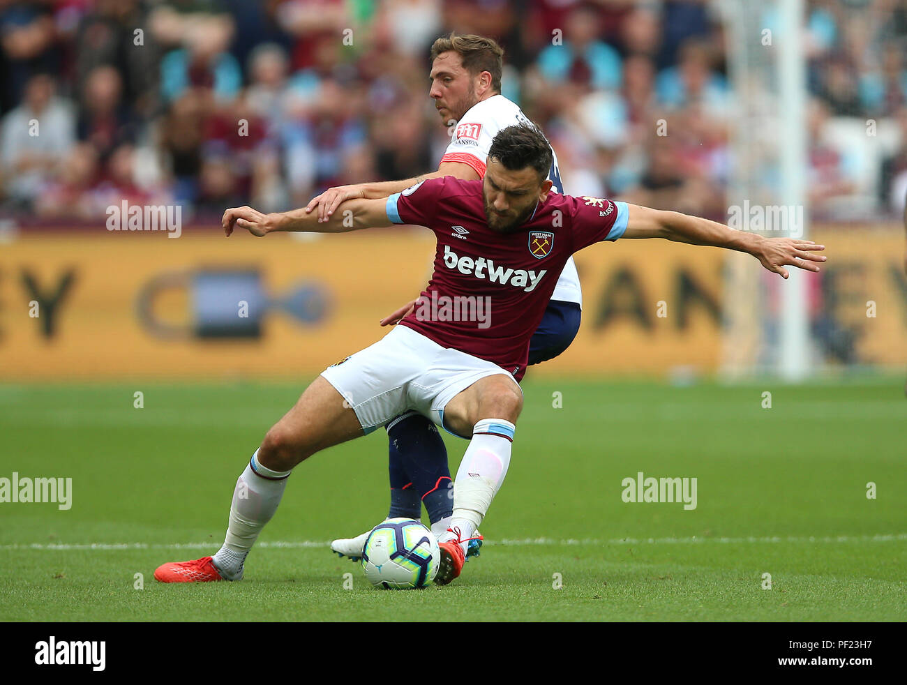 Bournemouth's Dan Gosling and West Ham United's Robert Snodgrass (left) battle for the ball during the Premier League match at London Stadium. Stock Photo