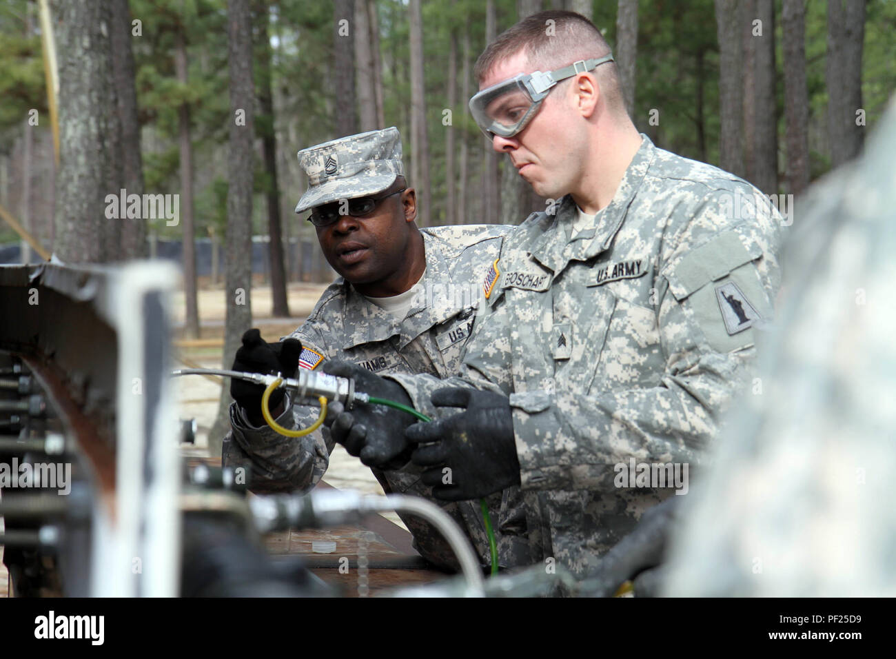 during-a-field-training-exercise-for-the-petroleum-supply-specialist-reclassification-course-at-fort-lee-va-sgt-1st-class-torron-williams-an-instructor-assigned-to-the-94thtraining-division-provides-guidance-to-one
