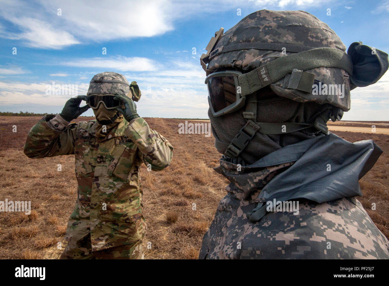 Staff Sgt. Robert Hames, left, sling load team leader, and Spc. Kevin Fletcher, both with the 404th Civil Affairs Battalion (Airborne), United States Army Reserve, adjust their protective gear during joint sling load training with the 1-150th Assault Helicopter Battalion, New Jersey Army National Guard, at Coyle Drop Zone, Joint Base McGuire-Dix-Lakehurst, N.J., Feb. 29, 2016. (U.S. Air National Guard photo by Master Sgt. Mark C. Olsen/Released) Stock Photo