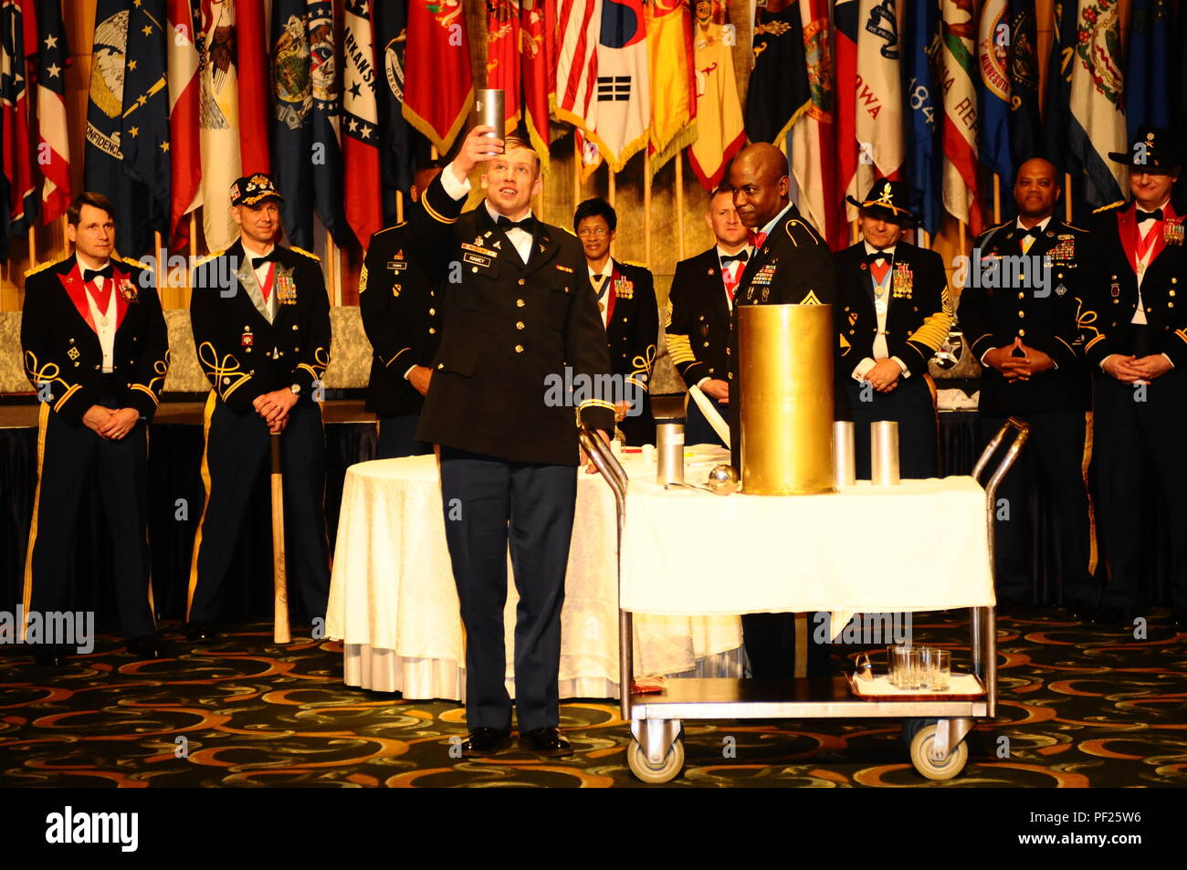 The senior leaders of 210th Field Artillery Brigade, 2nd Infantry Division/ROK-U.S Combined Division, stand ready while the Brigade’s most junior officer samples the mixed punch 'Grog,' Feb. 12, at the Lotte Hotel, Seoul. Drinking from the 'Grog Bowl' is a historical tradition seen at the Saint Barbara’s Day Ball, representing the strength and unity of the artillery Soldiers. Stock Photo