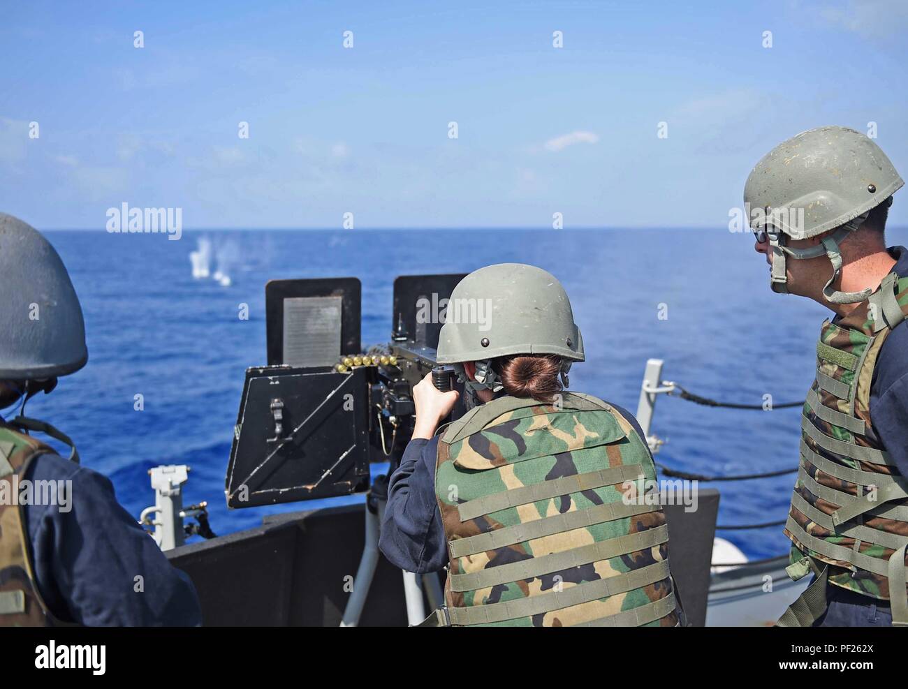 160228-N-KM939-188 PHILIPPINE SEA (Feb. 28, 2016) - Gunner’s Mate Seaman Ashley Koblitz, from Jacksonville, fires a .50-caliber machine gun during a small craft action team exercise aboard the guided-missile destroyer USS Stockdale (DDG 106). Providing a ready force supporting security and stability in the Indo-Asia-Pacific, Stockdale is operating as part of the John C. Stennis Strike Group and Great Green Fleet on a regularly scheduled 7th Fleet deployment. (U.S. Navy photo by Mass Communication Specialist 3rd Class David A. Cox/Released) Stock Photo