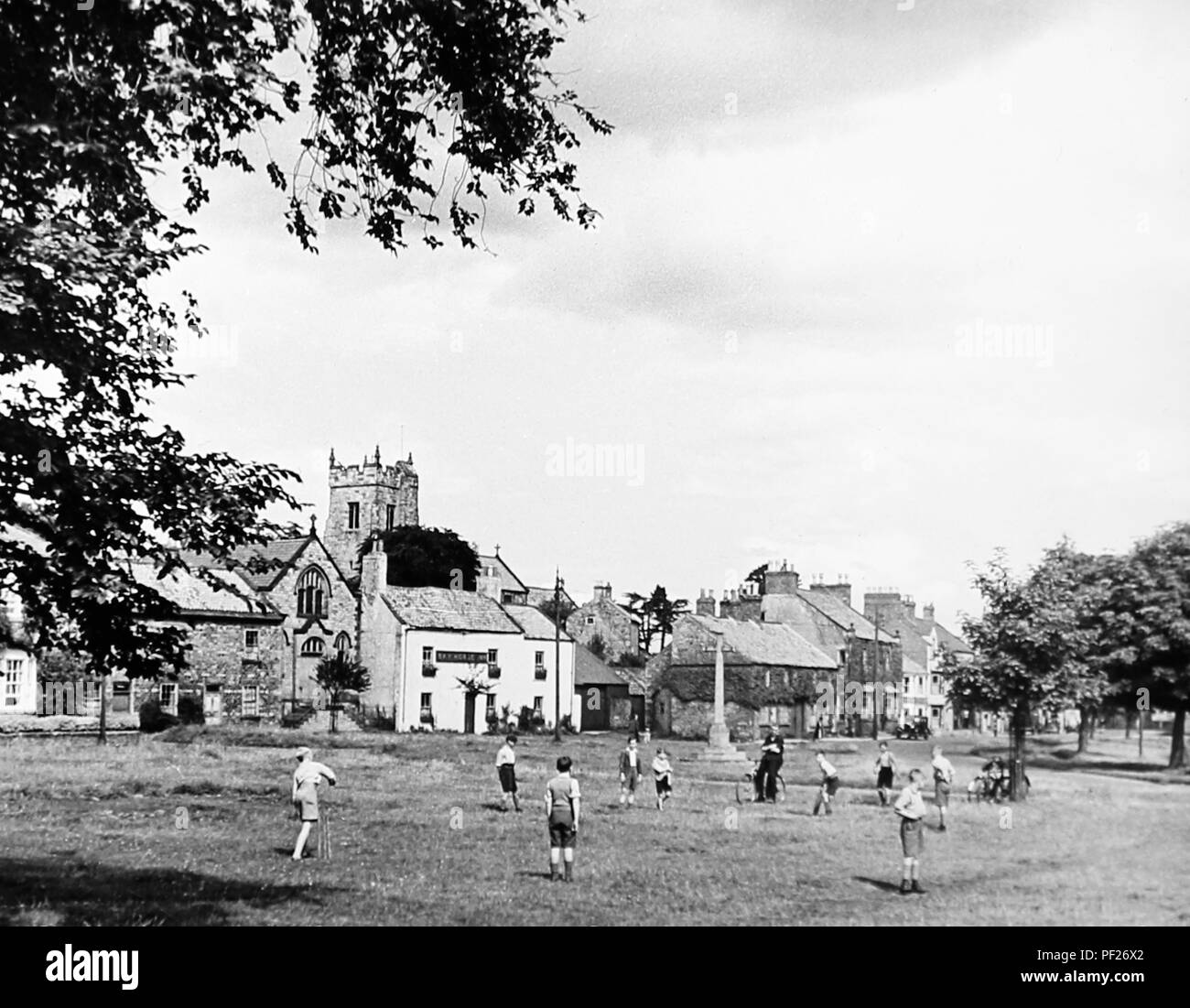 Children playing cricket, Catterick, in the 1930s Stock Photo