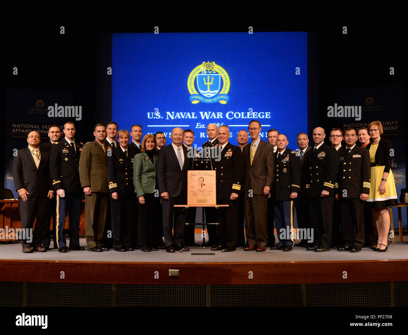 160226-N-PX557-214 NEWPORT, R.I. (Feb. 26, 2016) Rear Adm. P. Gardner Howe III, president, U.S. Naval War College (NWC), presents the James V. Forrestal Award for Excellence in Force Planning to top graduates of the 2016 National Security Decision Making (NSDM) course. The 10-week NSDM course is part of NWC's yearlong resident program and is designed to prepare senior level joint and international officers and civilians for executive positions in large national security organizations.   (U.S. Navy photo by Chief Mass Communication Specialist James E. Foehl/Released) Stock Photo