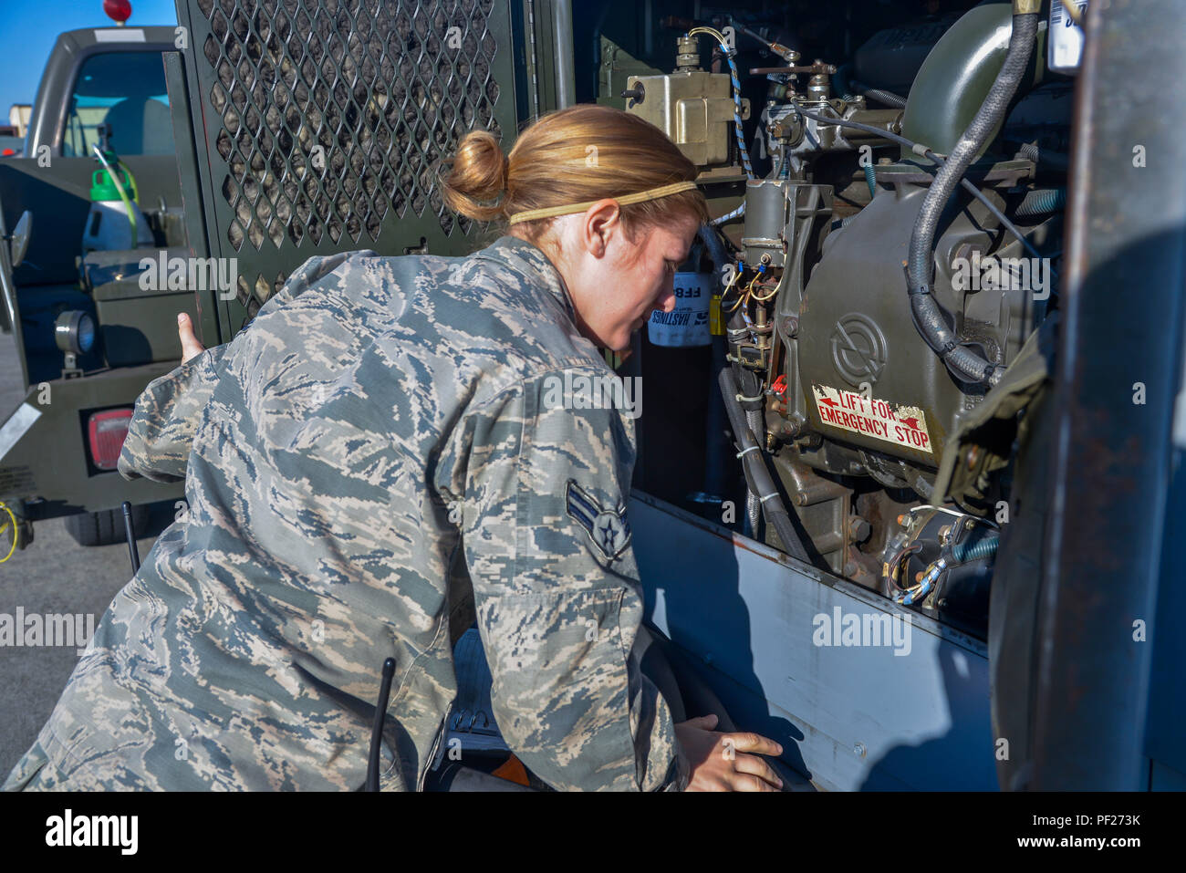 Airman 1st Class Abigail Kuras, 374th Maintenance Squadron Aerospace Ground  Equipment apprentice, performs a service inspection on a diesel generator  at Yokota Air Base, Japan, Feb. 11, 2016. The AGE flight maintains,