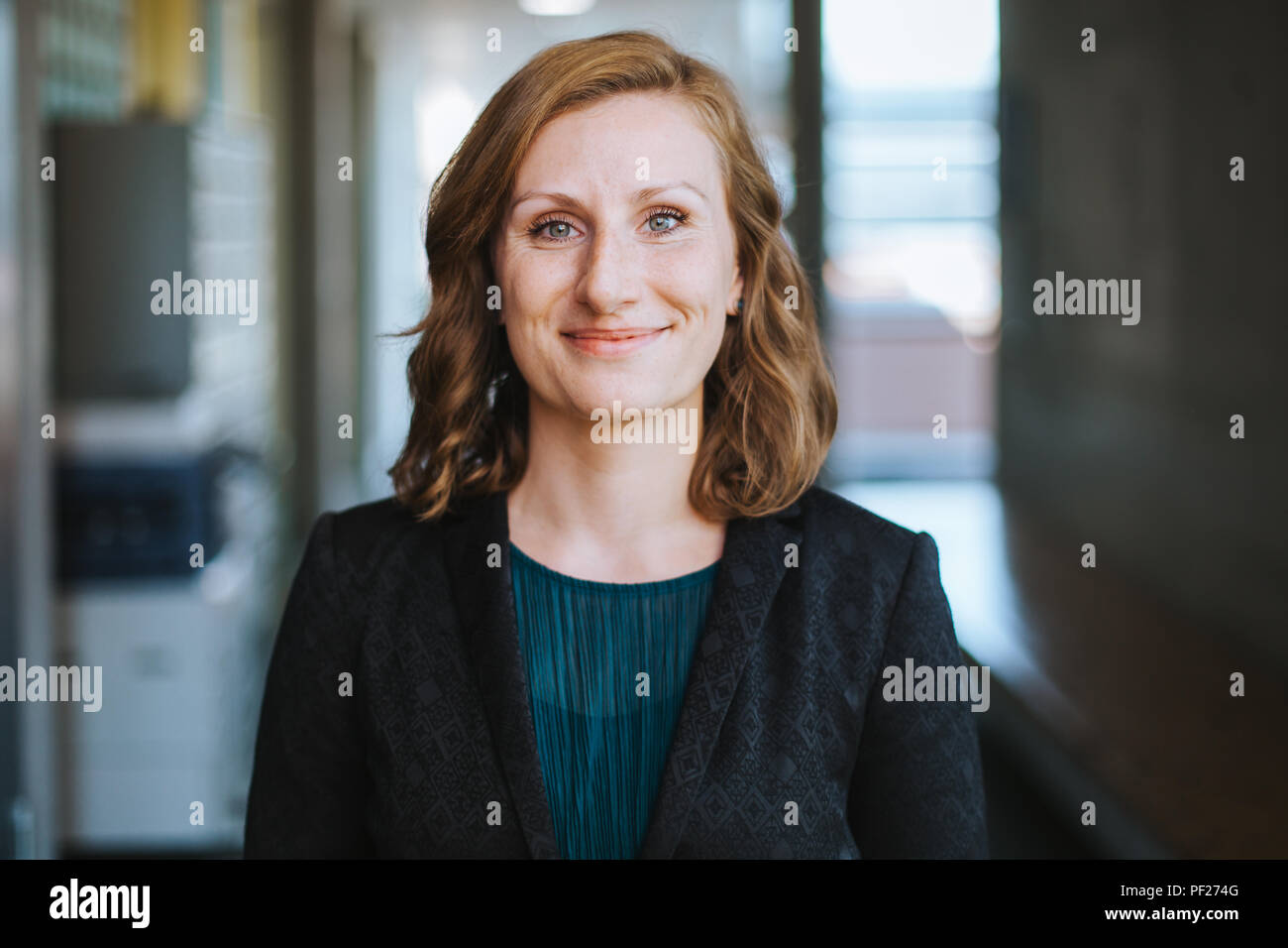 elegant and confident business woman smiles at the camera Stock Photo