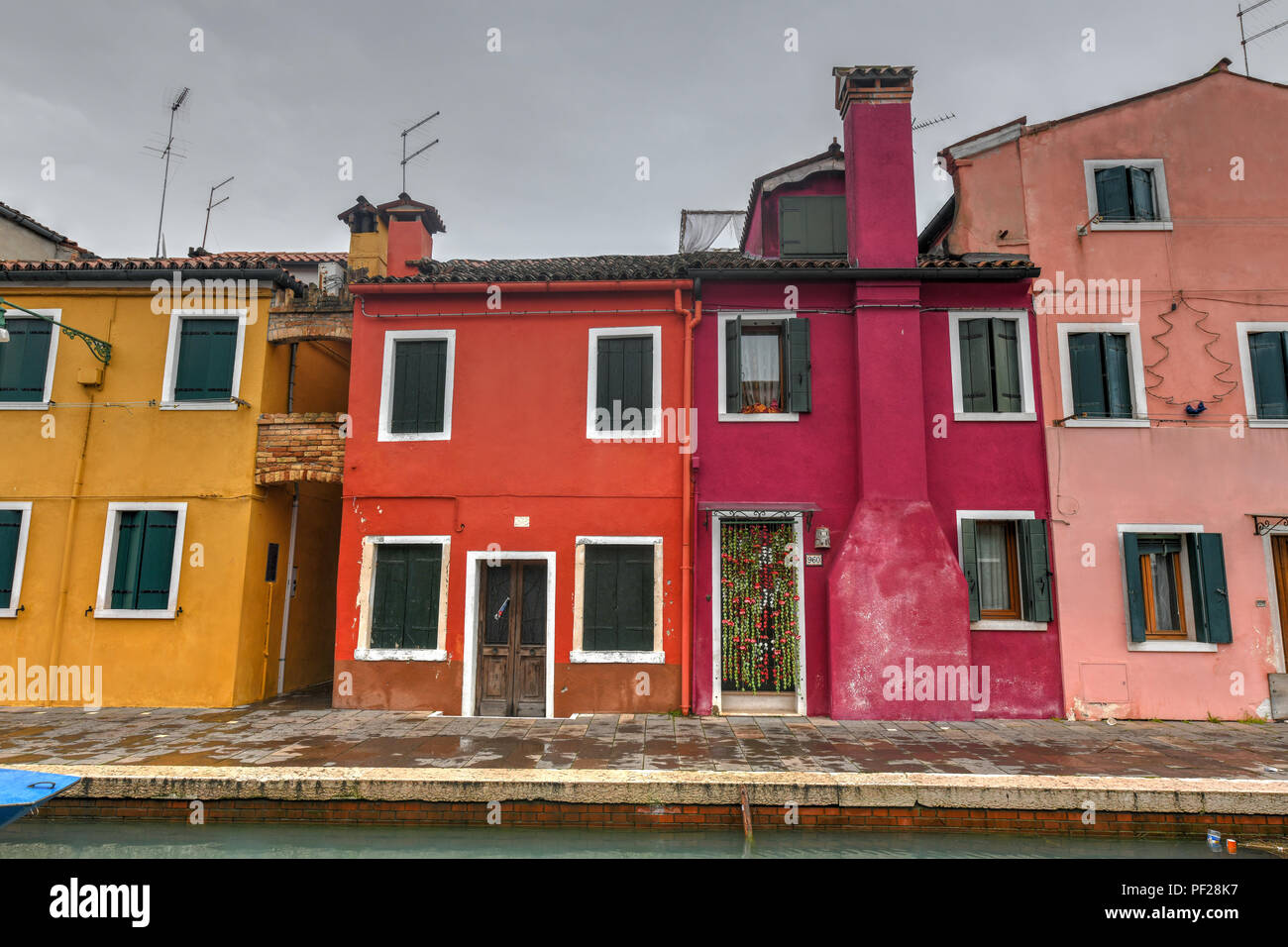 Colorful houses and canals of the island of Burano in Venice, Italy ...