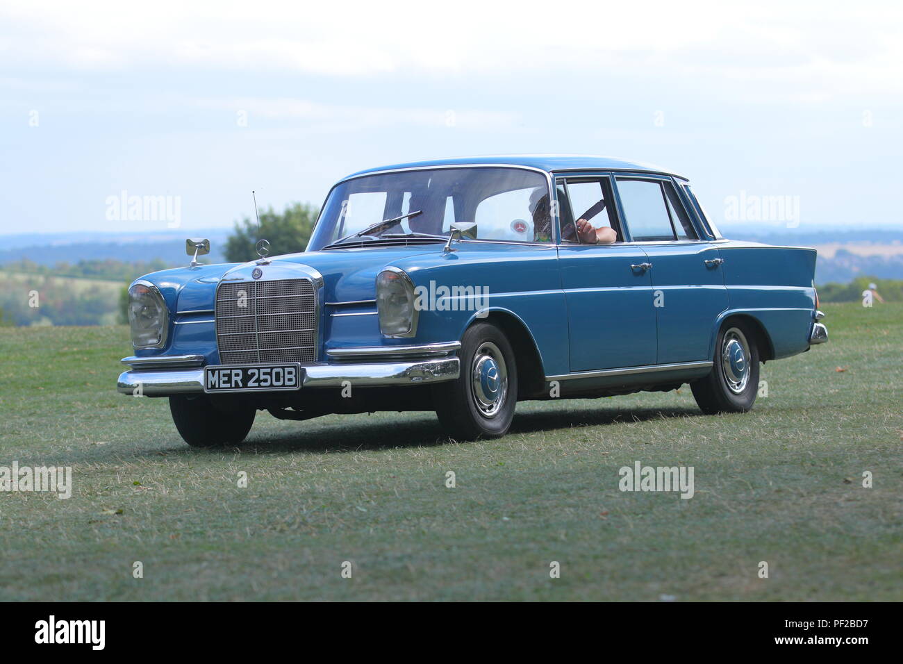 A 1964 Mercedes Benz 220 in Blue leaving  a Classic Car Show at Temple Newsam in Leeds Stock Photo