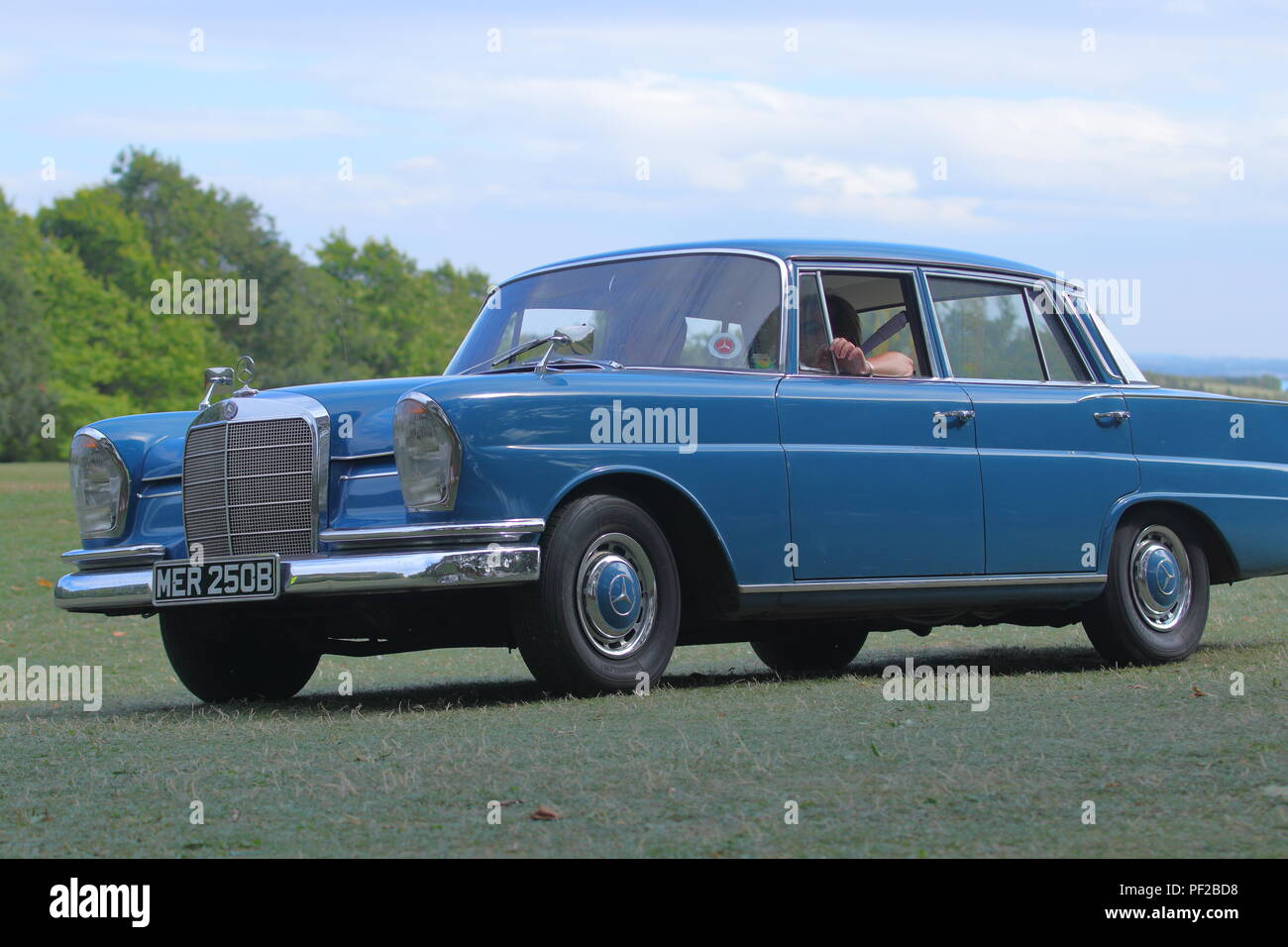 A 1964 Mercedes Benz 220 in Blue leaving  a Classic Car Show at Temple Newsam in Leeds Stock Photo