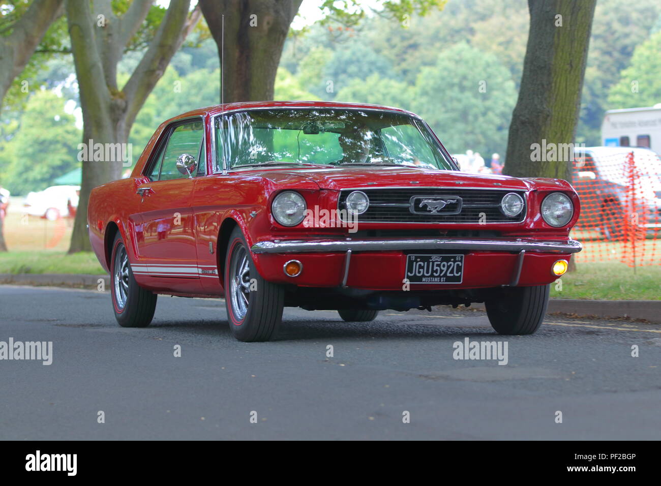A 1954 Red Ford Mustang leaving a Classic Car Show at Temple Newsam in Leeds Stock Photo