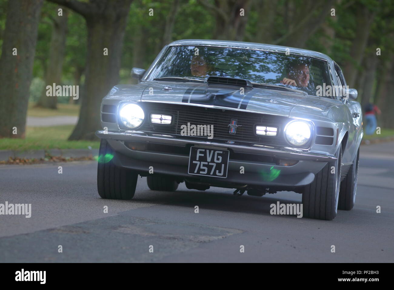 A Ford Mustang Mach 1 leaving a classic car show in Leeds Stock Photo