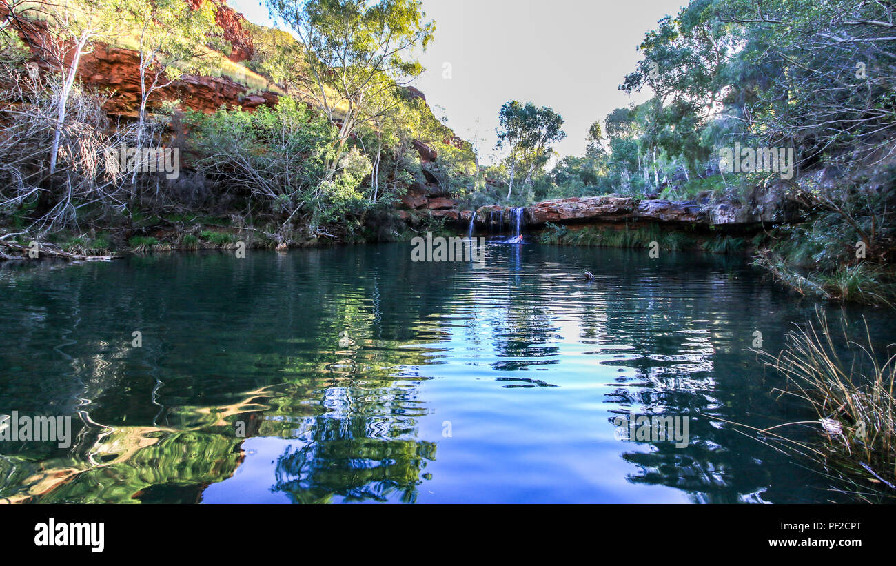 Waterfall flowing over rock into tranquil Fern pool Stock Photo - Alamy