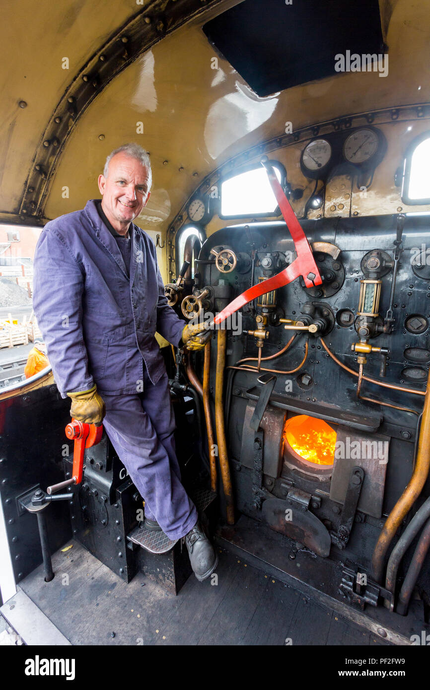 The driver of a steam train on the footplate  prior to departure from Minehead station on the West Somerset Railway, England, UK Stock Photo