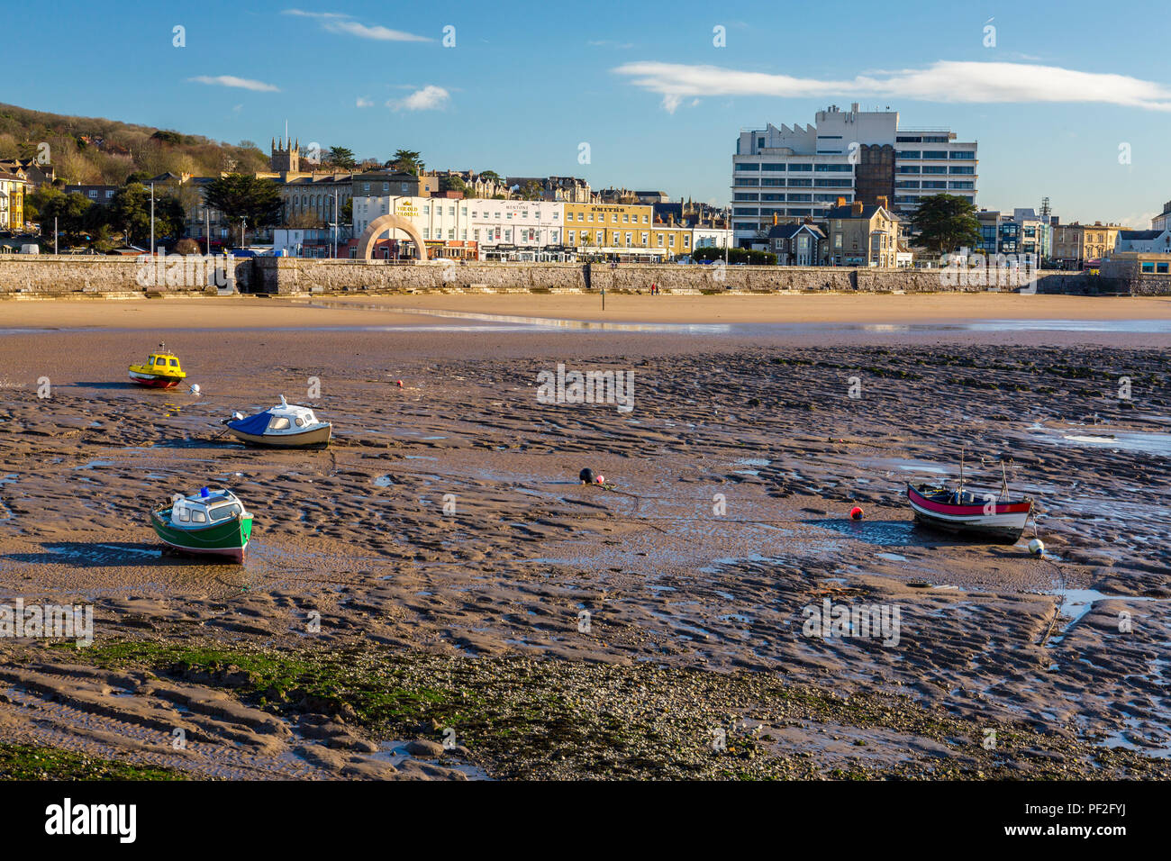 A deserted beach and colourful boats at low tide in winter at Weston-super-Mare, North Somerset, England, UK Stock Photo