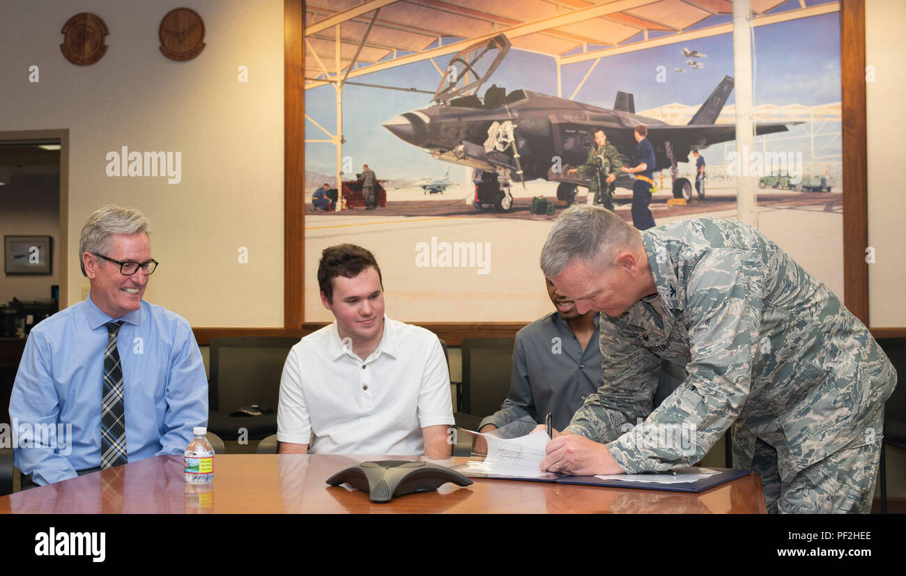 U.S. Air Force Col. Robert Sylvester, 56th Mission Support Group commander, signs an educational opportunities memorandum with the West Maricopa Education Center Aug. 14, 2018, at Luke Air Force Base, Ariz. The memorandum will allow West-MEC’s Project SEARCH to bring 10 interns ages 18-30 onto Luke to work side by side with military members and learn vital skills that they can use to find a well-paying job. (U.S. Air Force Photo by Tech. Sgt. Clinton Atkins) Stock Photo