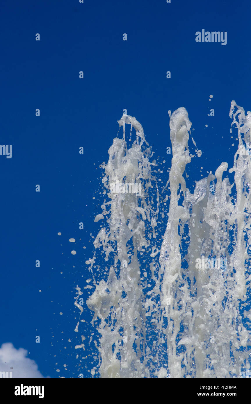 Fountain in city park on hot summer day, beautiful bright streams of