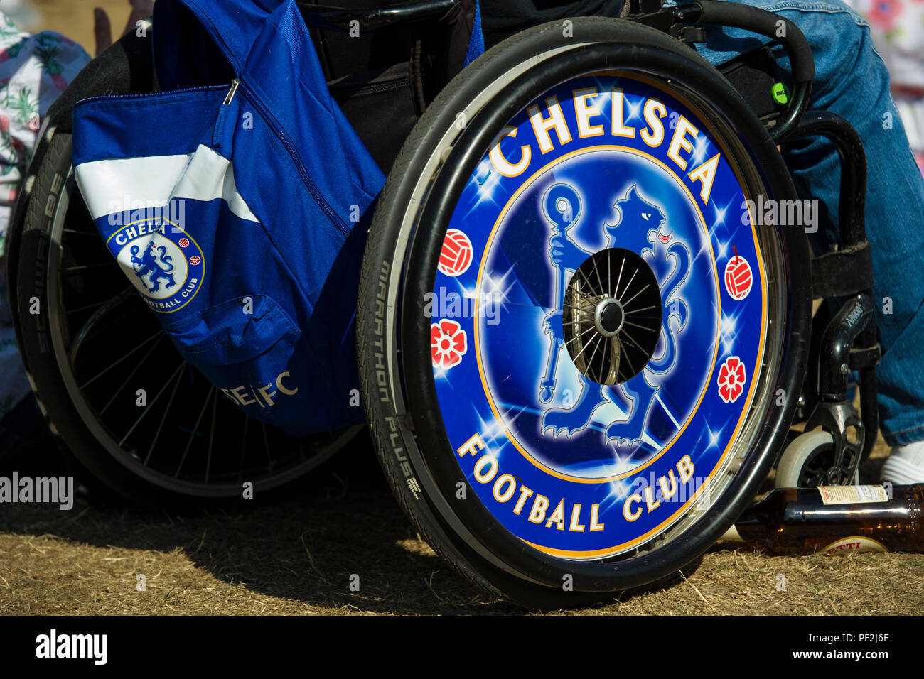 A close up of a Chelsea Football Club fan's wheelchair with CFC hub caps  and ruck sack Stock Photo - Alamy