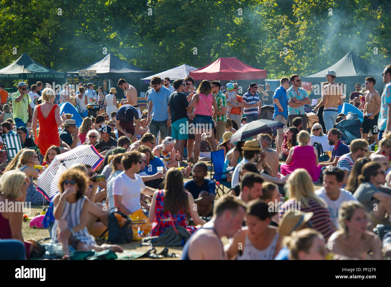 Crowds enjoying an open air music festival on a hot day in London Stock