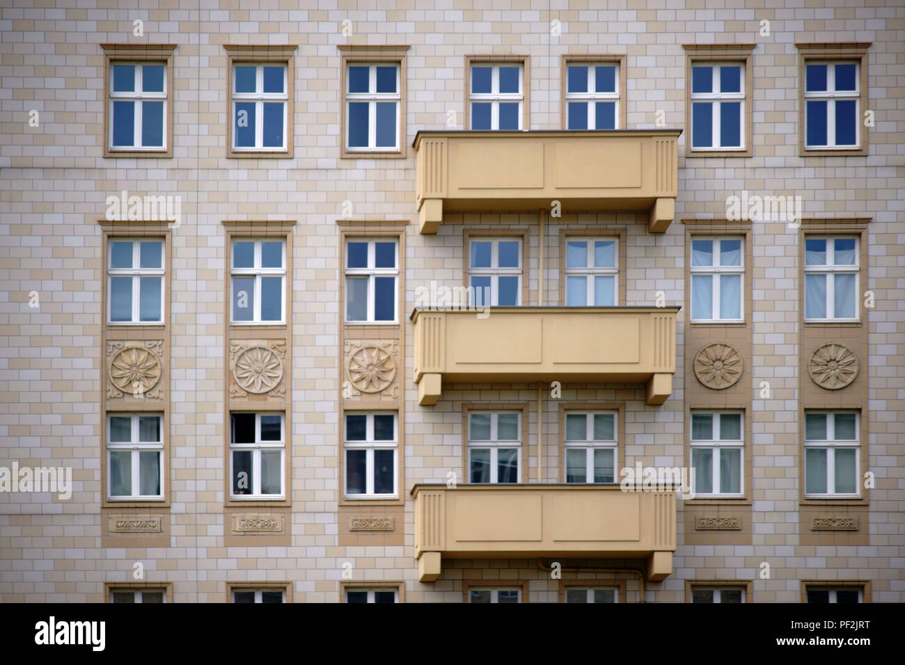 The facade of an old residential building with a clinker facade and a nostalgic balcony. Stock Photo