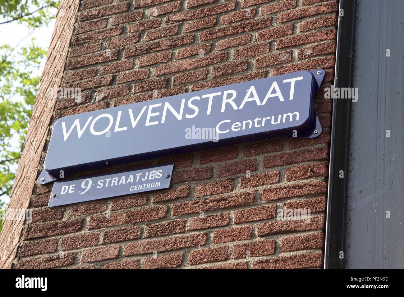 Blue street name sign for Wolvenstraat, part of de 9 straatjes or the nine streets in Amsterdam Stock Photo