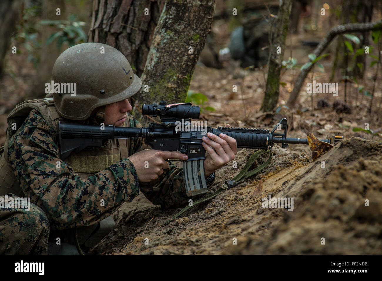 A U.S. Navy Corpsman assigned to Field Medical Training Battalion East (FMTB-E), provides security during a final exercise (FINEX) at Camp Johnson, N.C., Feb. 29, 2016. FINEX is a culminating event at FMTB-E which transitions Sailors into the Fleet Marine Force. (U.S. Marine Corps photo by Sgt. James R. Skelton/Released) Stock Photo