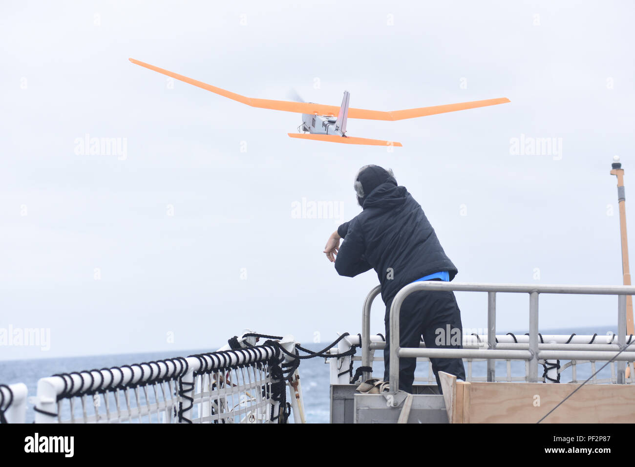 Kevin Vollbrecht, an engineering development technician with Aerovironment Inc., launches a PUMA AE unmanned aircraft system from the flight deck of Coast Guard Cutter Polar Star during Operation Deep Freeze 2016 in the Southern Ocean Jan. 3, 2016. The UAS will play a role in selecting the optimal route through pack ice as the cutter transits to McMurdo Station, Antarctica. (U.S. Coast Guard photo by Petty Officer 2nd Class Grant DeVuyst) Stock Photo