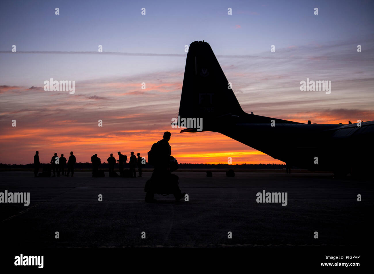 Aircrew from the 71st Rescue Squadron and jumpers from the 93d Air Ground Operations Wing prepare to board an HC-130J Combat King II, Feb. 17, 2016, at Moody Air Force Base, Ga.  Multiple U.S. Air Force aircraft within Air Combat Command conducted joint aerial training at Grand Bay Bombing and Gunnery Range. During the training, the aircraft conducted tactical air and ground maneuvers, as well as weapons training. (U.S. Air Force photo by Senior Airman Ryan Callaghan/Released) Stock Photo