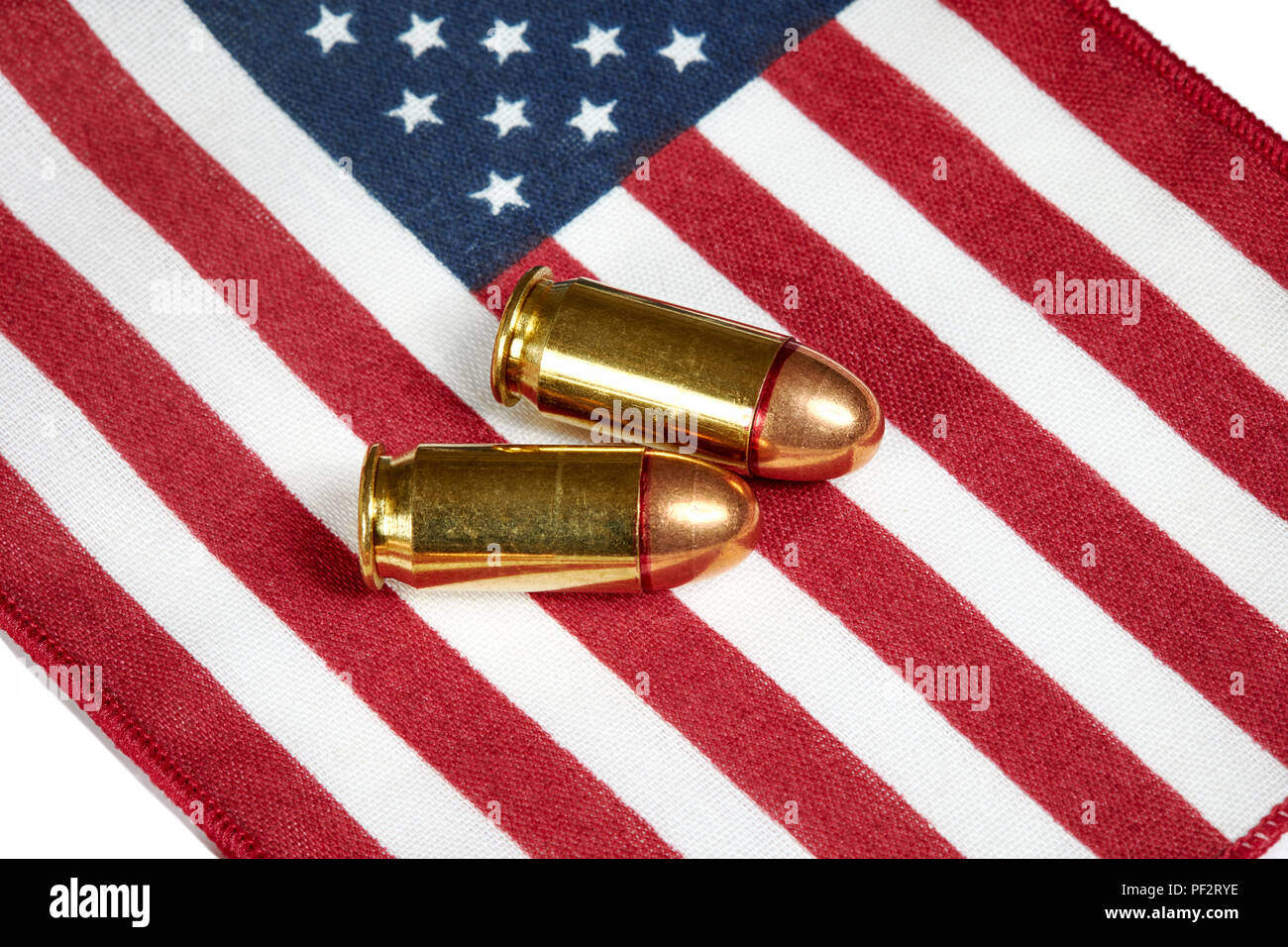 Two .45 caliber bullets on an American Flag Stock Photo