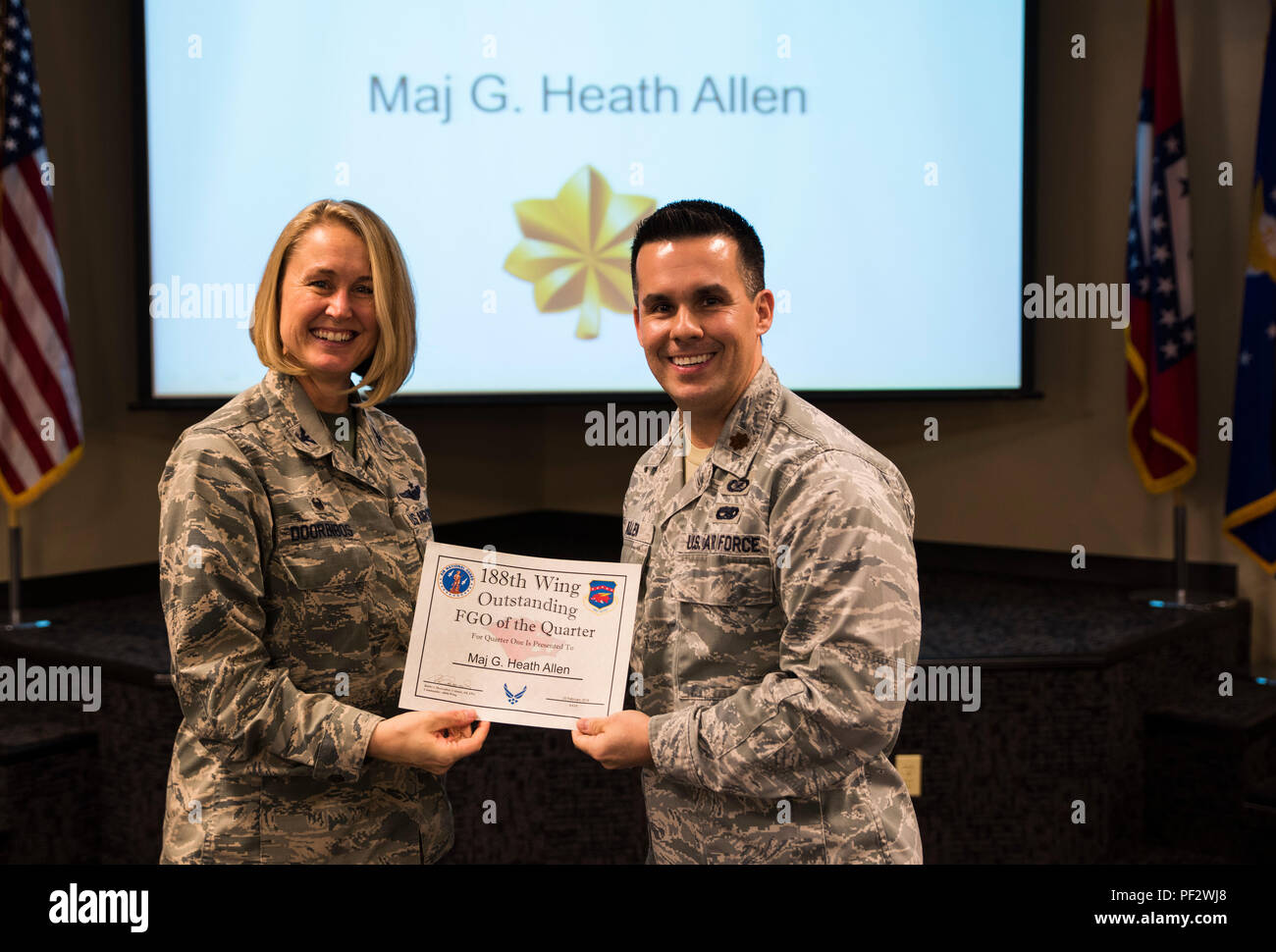 Maj. Heath Allen, 188th Wing executive officer, accepts the Outstanding