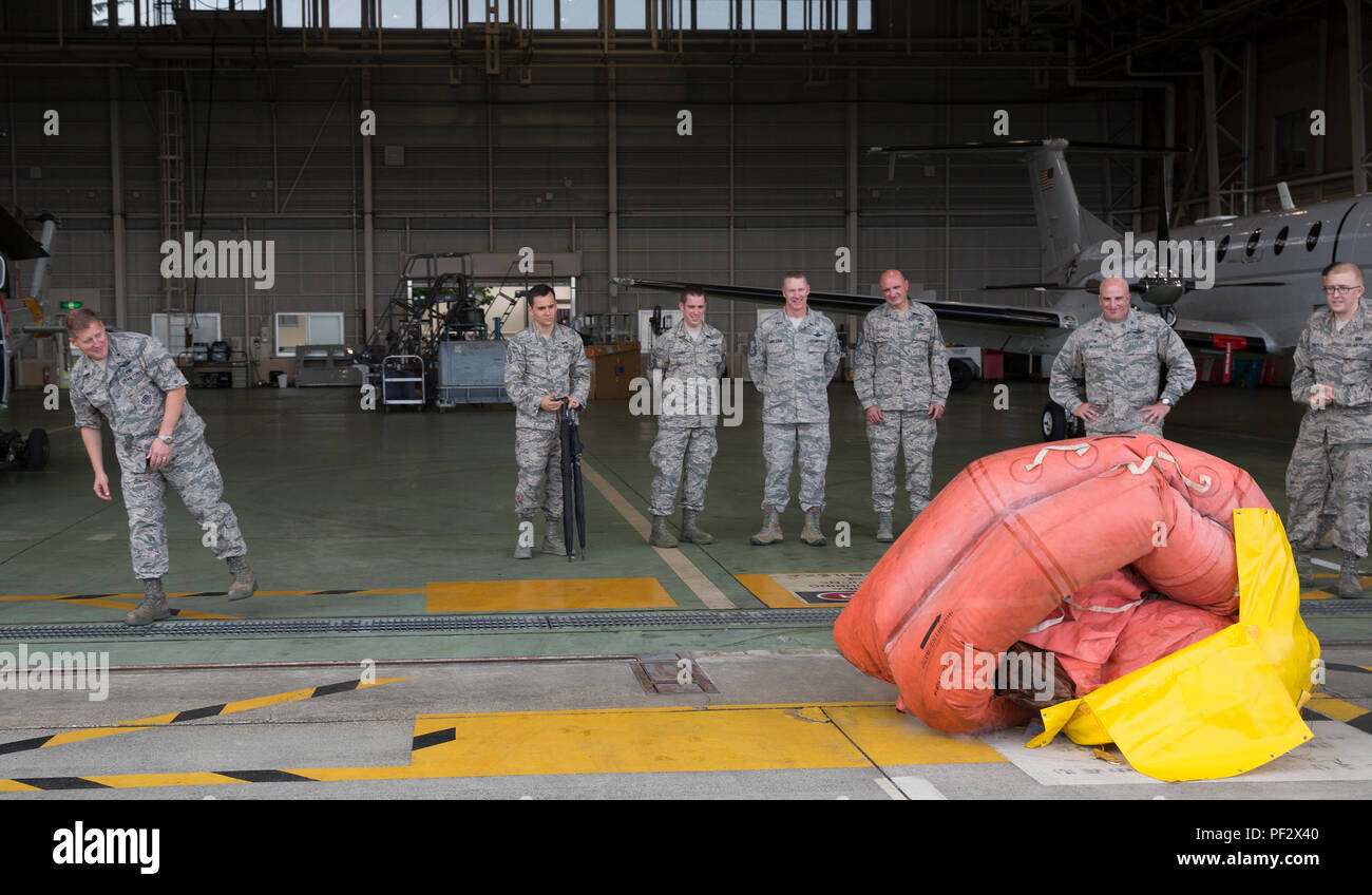 Brig. Gen. Michael Winkler, 5th Air Force vice commander, watches a F-2B life raft inflate during his immersion tour at Yokota Air Base, Japan, Aug. 2, 2016. Aircrew Flight Equipment specialists with the 374th Operations Support Squadron make sure aircrew have the supplies necessary for their missions. The team of AFE Airmen pack emergency items such as parachutes and survival kits and also maintain helmets and oxygen masks. (U.S. Air Force photo by Yasuo Osakabe/Released) Stock Photo