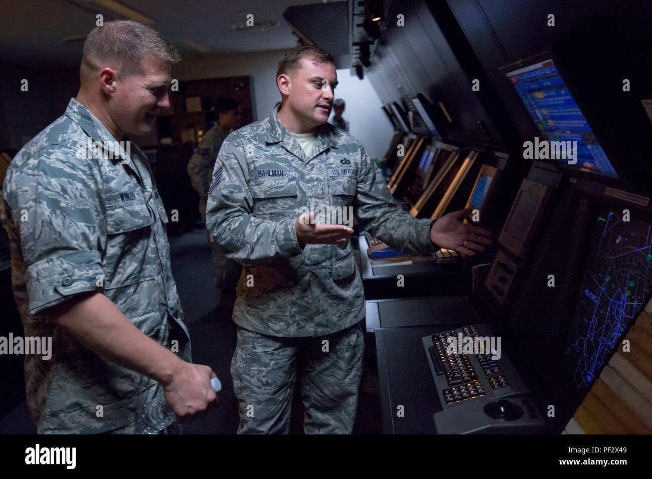 Tech. Sgt. Christopher Bahlman, 374th Operations Support Squadron air traffic control specialist, gives a brief on the operation of an approach control station to Brig. Gen. Michael Winkler, 5th Air Force vice commander, during his immersion tour at Yokota Air Base, Japan, Aug. 2, 2016. Yokota’s Radar Approach Control Airmen monitor and control aircraft over a 20,000 square mile area. (U.S. Air Force photo by Yasuo Osakabe/Released) Stock Photo