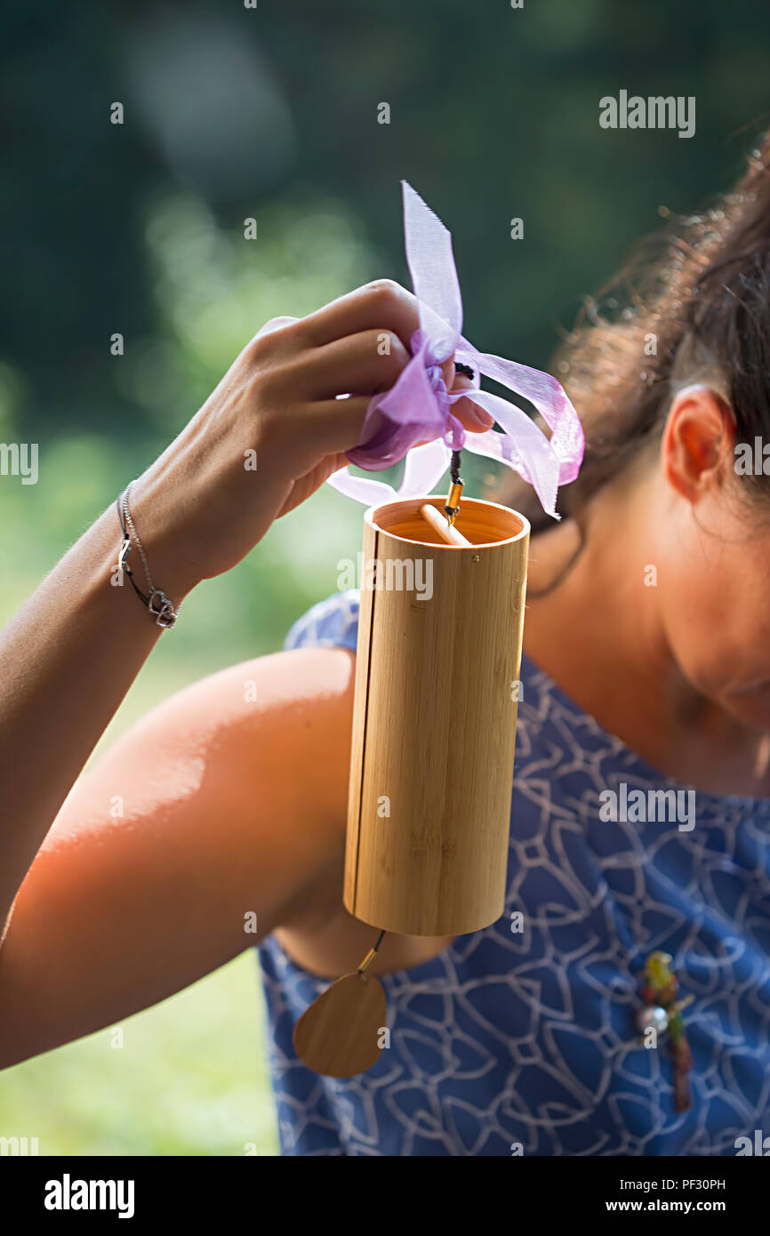 Girl holding Koshi wind chime sound therapy Stock Photo Alamy