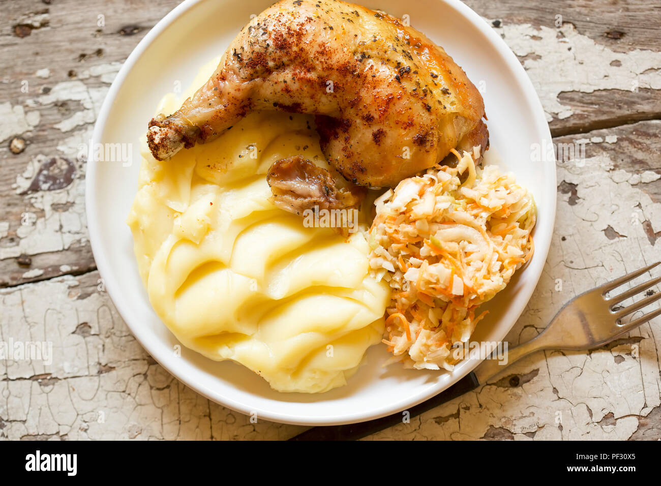 Roasted chicken leg with mashed potatoes and coleslaw Stock Photo Alamy