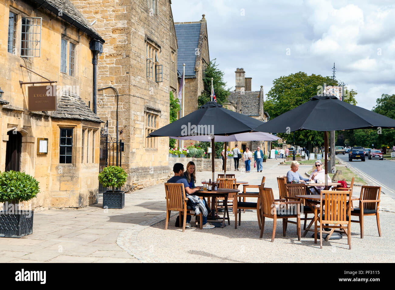 Broadway, UK - 8th August 2018: People enjoy summer day in Broadway, small town in the Cotswold district of Worcestershire,, England, which is often r Stock Photo