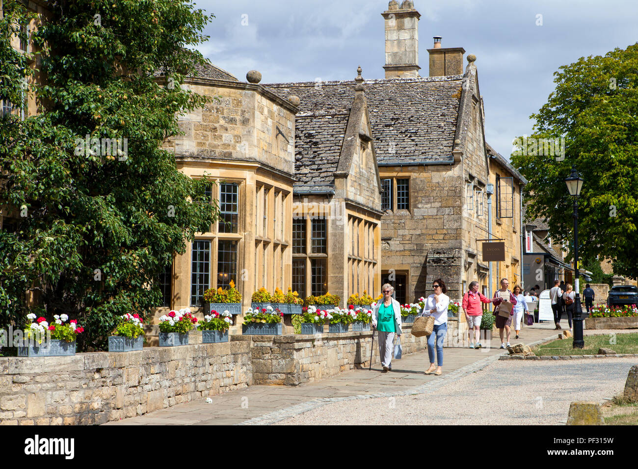 Broadway, UK - 8th August 2018: People enjoy summer day in Broadway, small town in the Cotswold district of Worcestershire,, England, which is often r Stock Photo