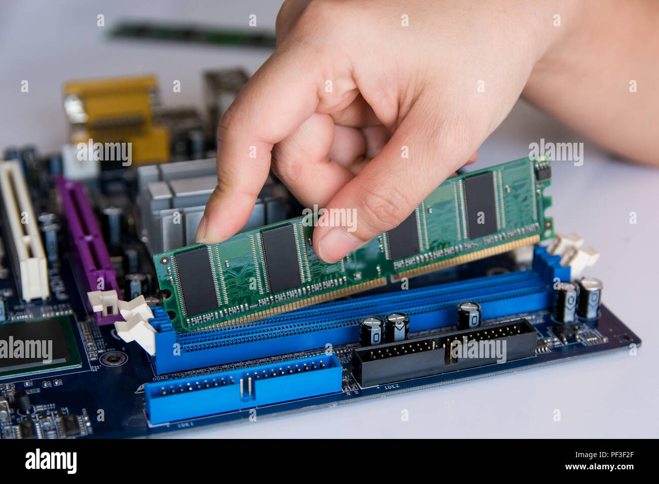 Technician installing RAM stick (random access memory) to socket on  motherboard Stock Photo - Alamy