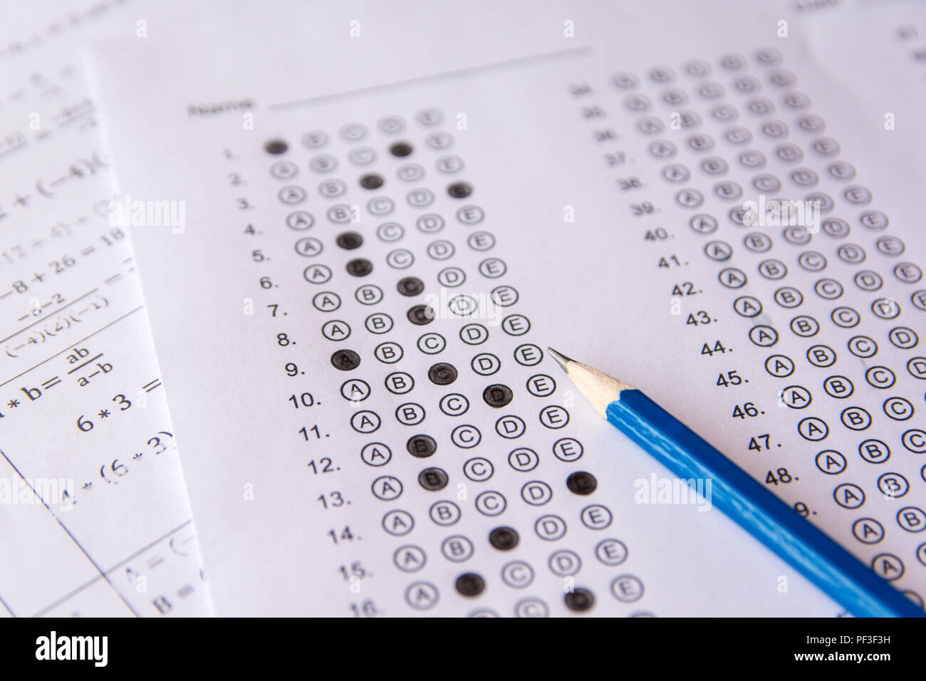 Pencil on answer sheets or Standardized test form with answers bubbled. multiple choice answer sheet Stock Photo