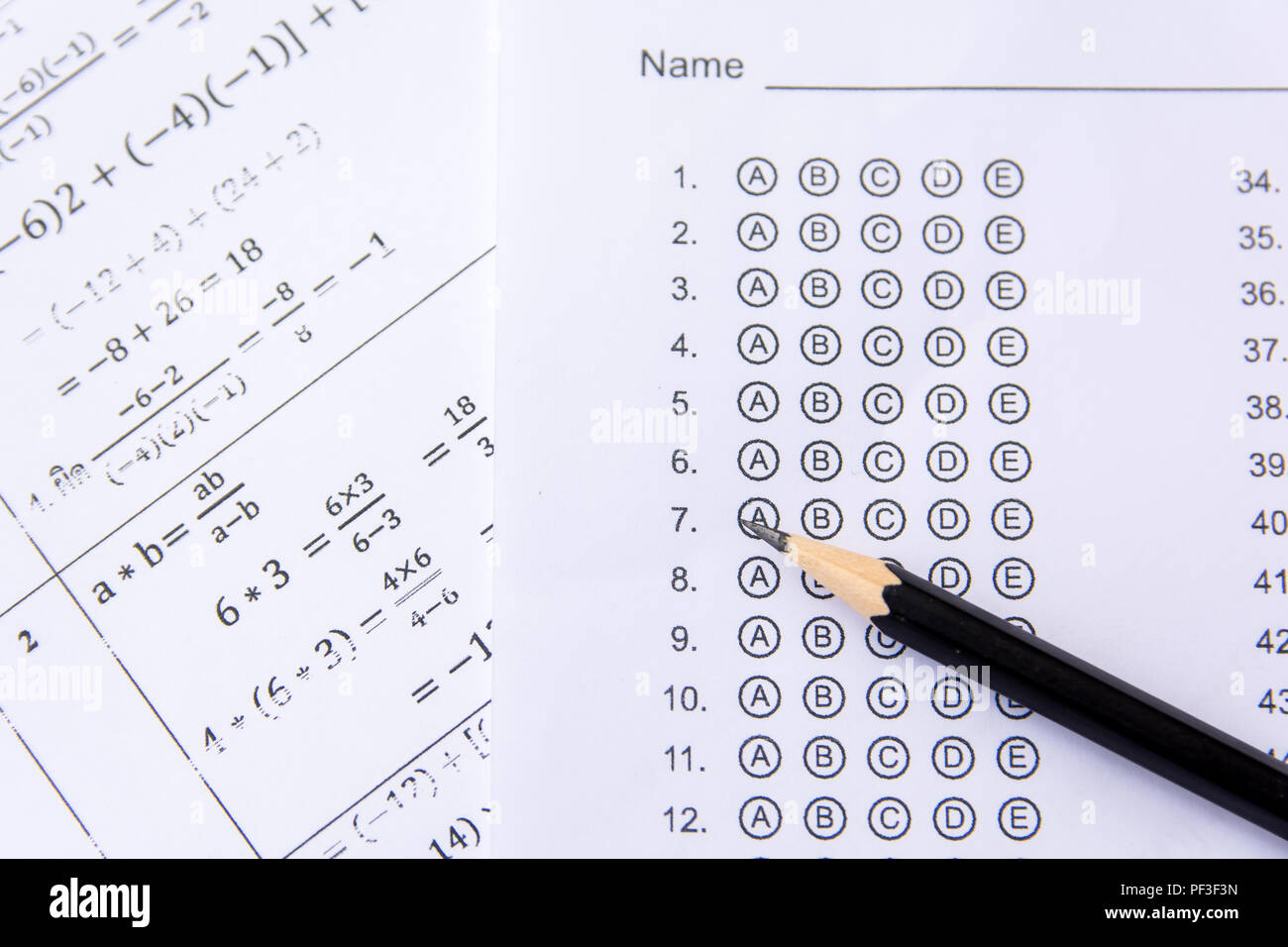 Pencil on answer sheets or Standardized test form with answers bubbled. multiple choice answer sheet Stock Photo