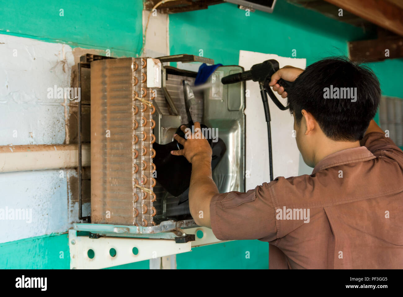 Technician are servicing repairing and air conditioners. Clean