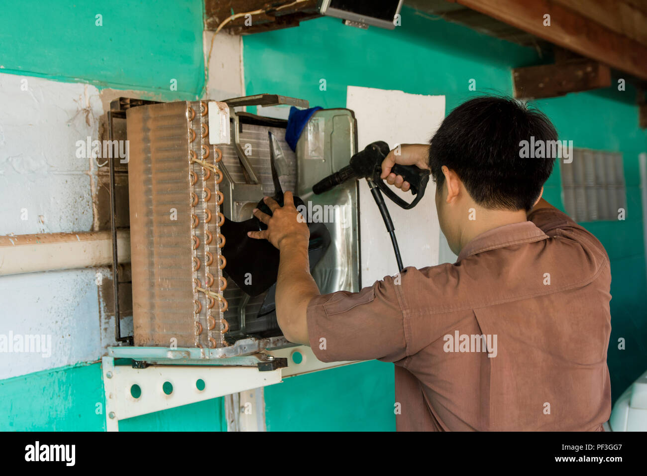 Technician are servicing repairing and air conditioners. Clean