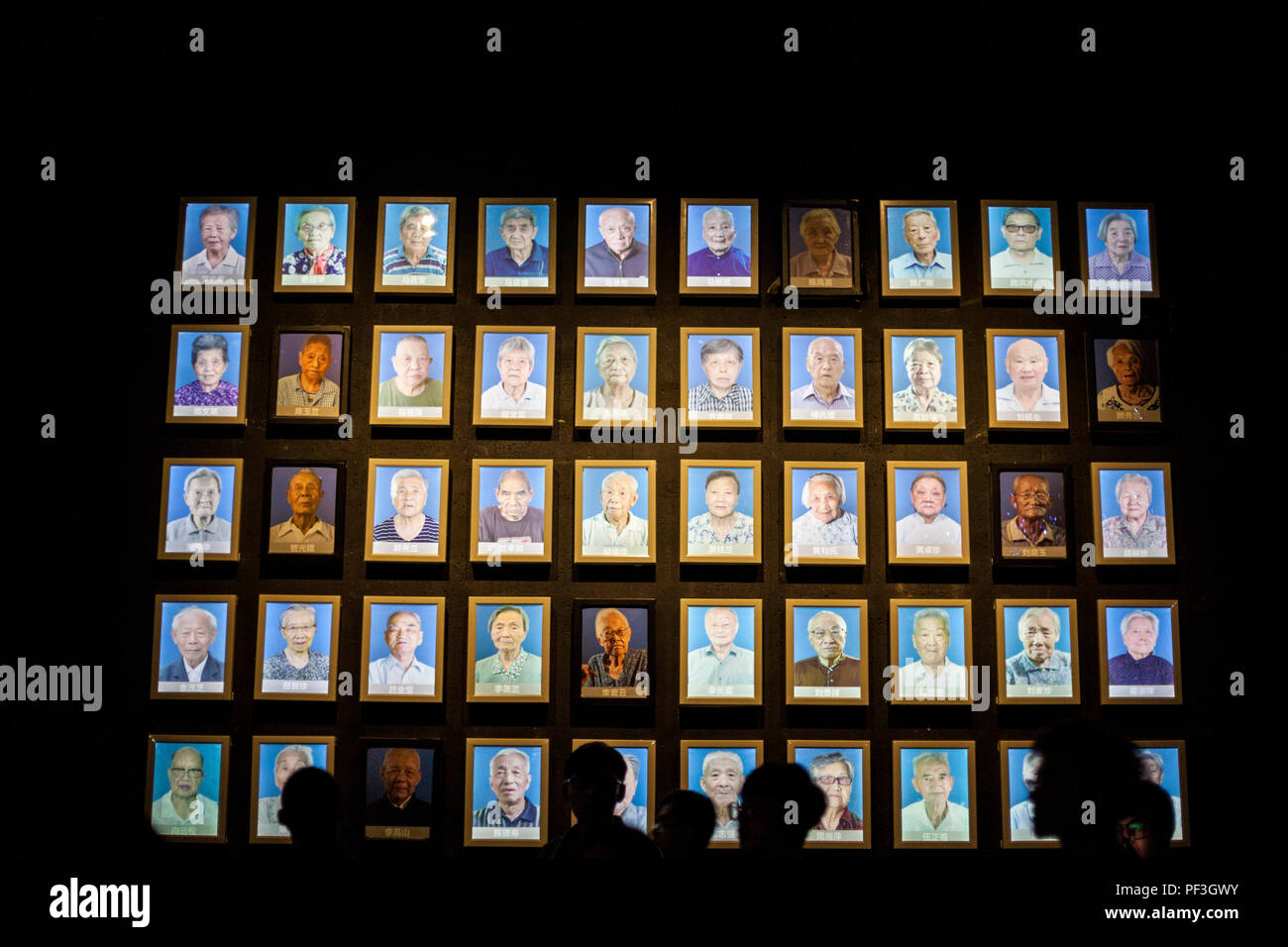 Nanjing, Jiangsu, China.  Survivors of the Nanjing Massacre.  Darkened Photos are of those who have died since the museum exhibit was finished. Stock Photo