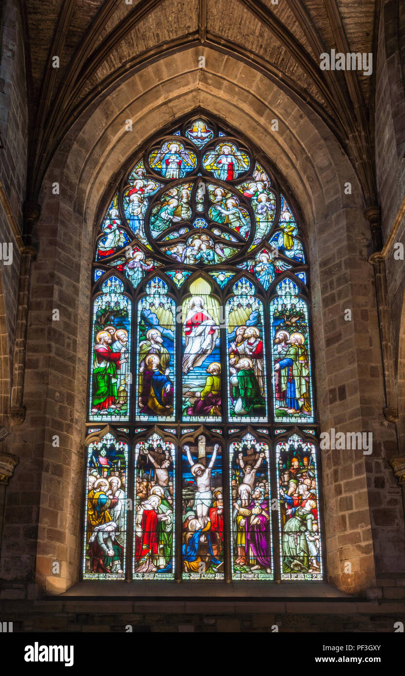 Edinburgh, Scotland, UK - June 13, 2012; St Giles Cathedral. Stained window behind chancel featuring calvary scene with three people on crosses and as Stock Photo