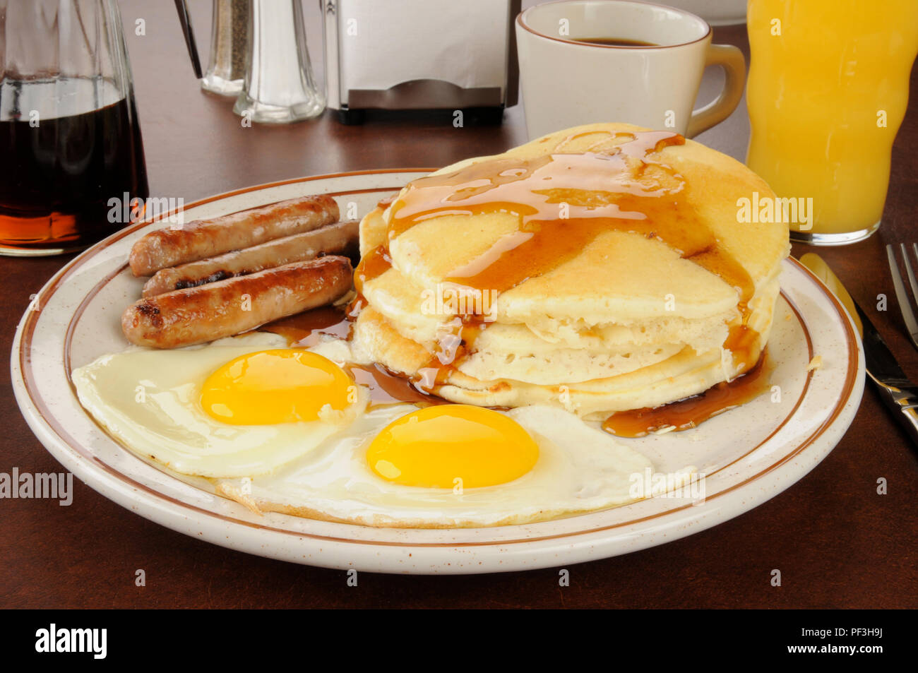 A sausage and egg breakfast with pancakes Stock Photo Alamy