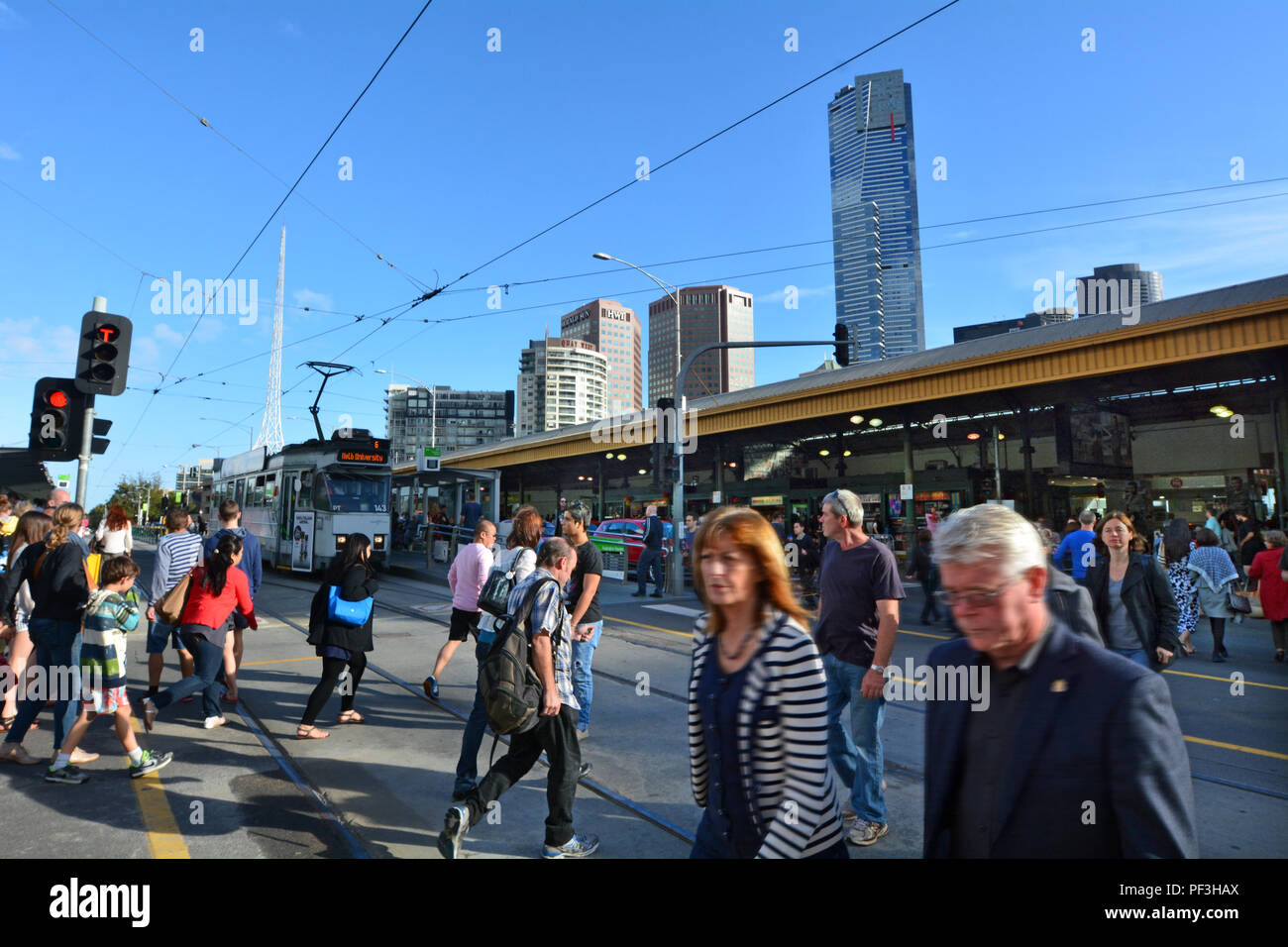 MELBOURNE - APR 13 2014:Pedestrians cross Flinders Street towards Flinders Street railway station.It's on of the most busiest pedestrian crossings in  Stock Photo