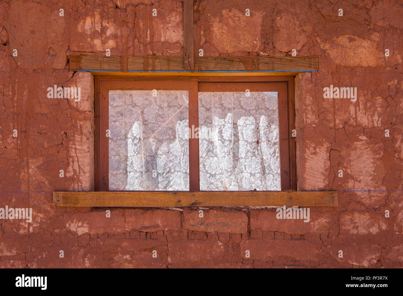 Window With Lace Curtains In A Red Brick Wall Stock Photo