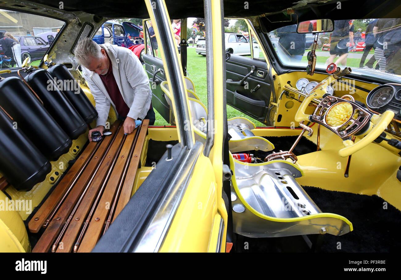 Paul Aveil works on his customised 1972 Mercedes W114 during the London Cartel International Auto Show, at the South of England Showground, West Sussex, where over 2000 classic and retro cars are being showcased. Stock Photo