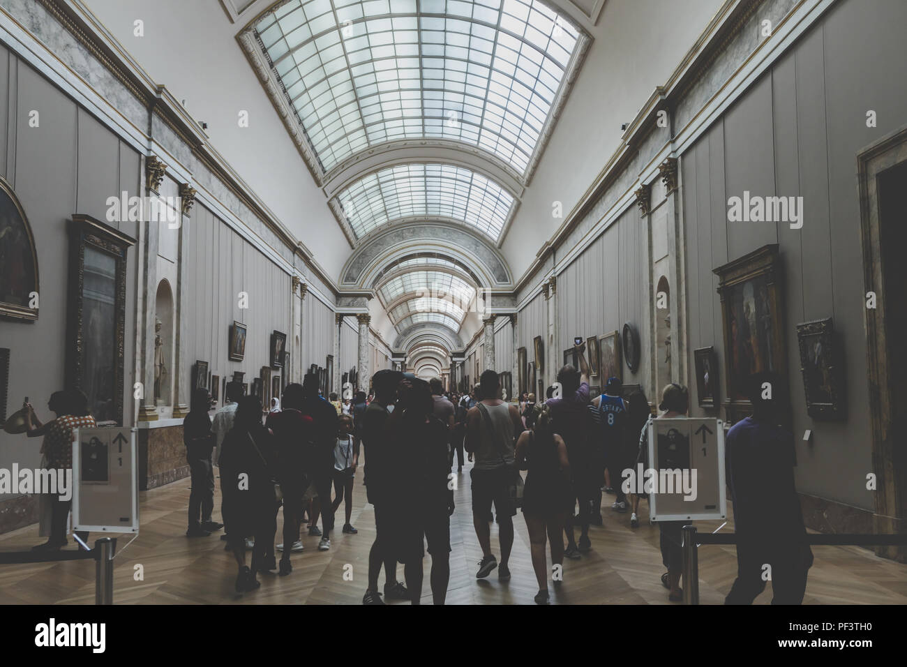 Inside a hall of artworks at the Louvre art museum in Paris – August 2018 Stock Photo