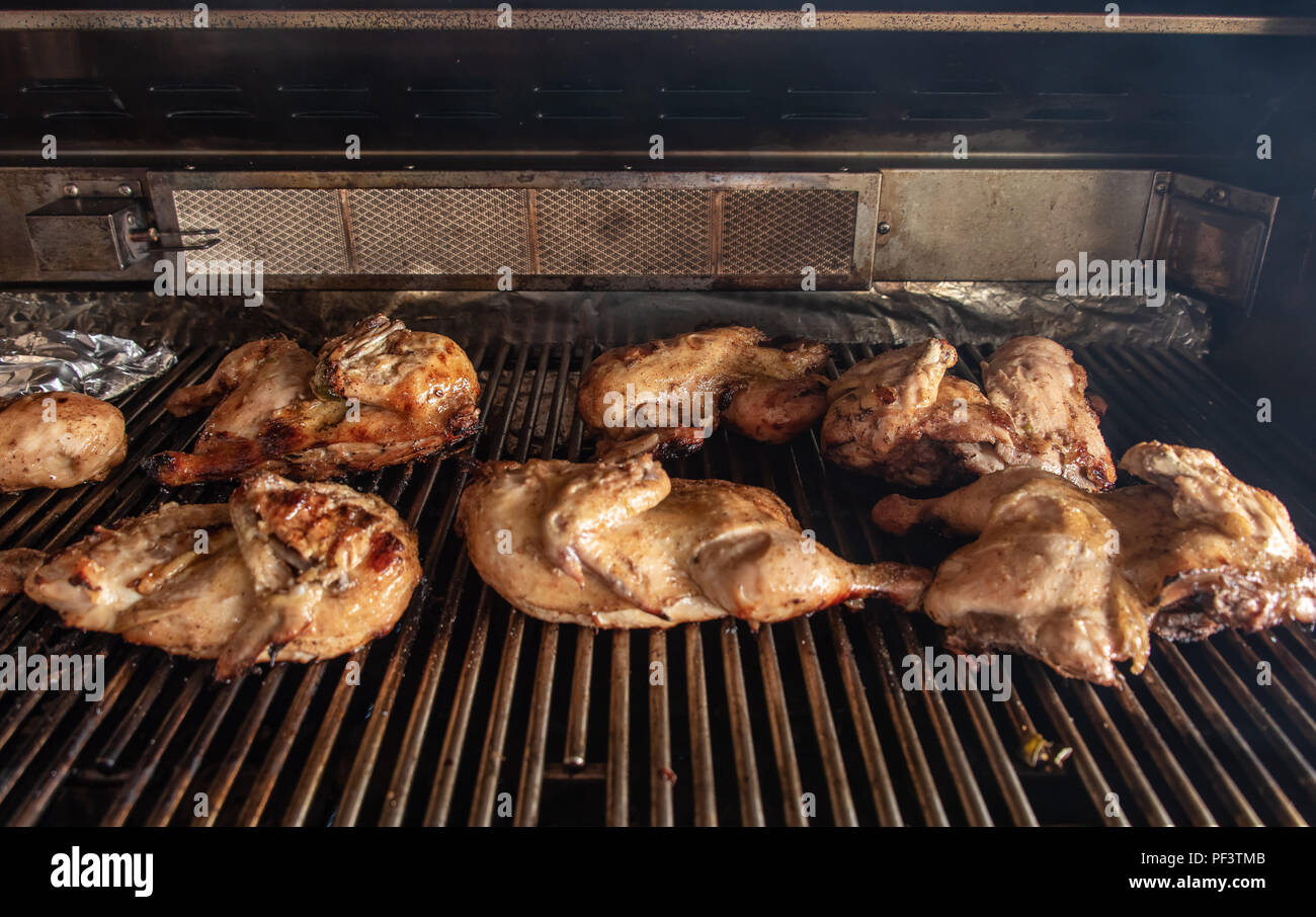 Chickens Roasting On A Gas Grill Stock Photo Alamy